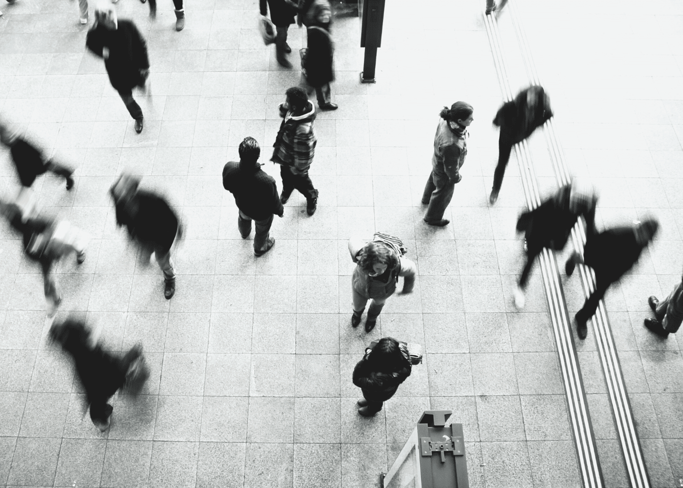 People waking quickly in different directions with a blur photo effect