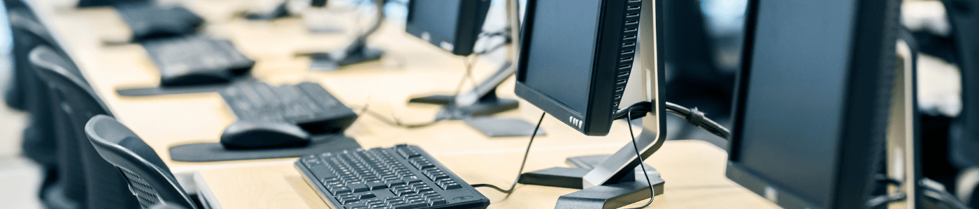 Row of desktops on a table
