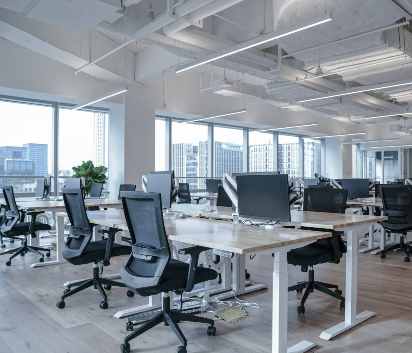 Interior of an office building set up with desks, chairs, and computers