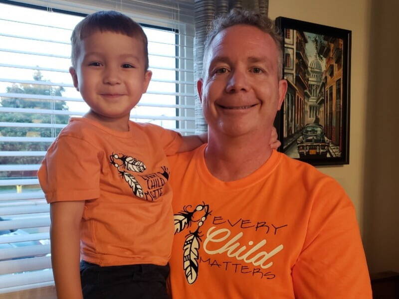 PeopleToGo's managing partner and his son proudly wear an orange shirt for orange shirt day - a cause that supports Indigenous communities 